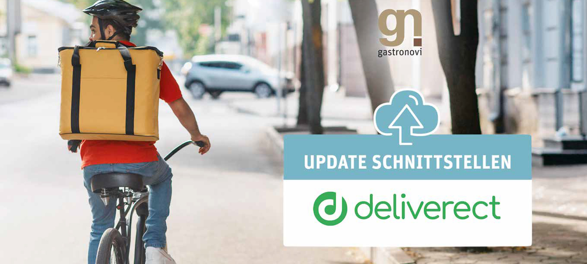 Ein Fahrrad-Kurier fährt eine Straße entlang