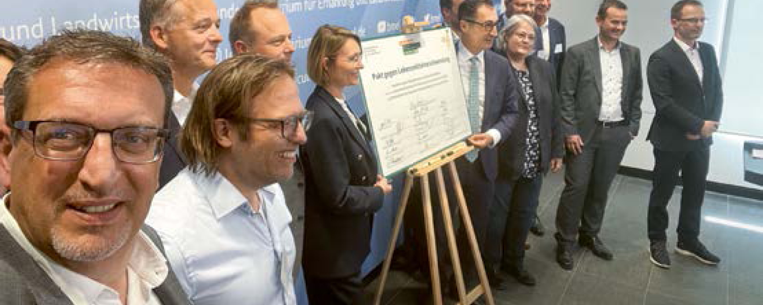 Selfie von Manfred Hofer mit Bundeslandwirtschaftsminister Cem Özdemir und weiteren Vertretern wichtiger Groß- und Einzelhandelsunternehmen vor dem unterzeichneten "Pakt gegen Lebensmittelverschwendung"